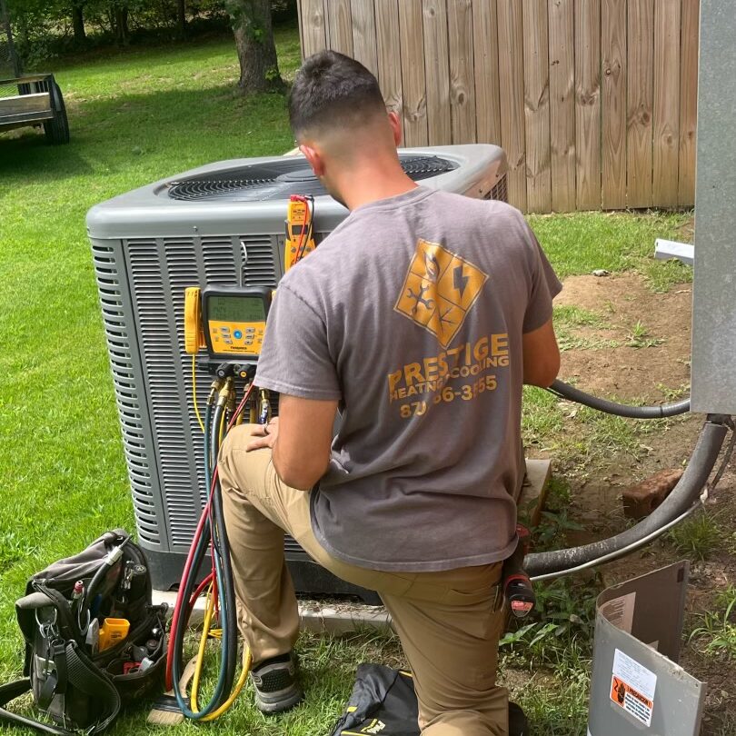 Hunter Carr, Owner, repairing HVAC unit